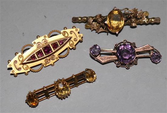 Four early 20th century 9ct gold gem set bar brooches, largest 2in.